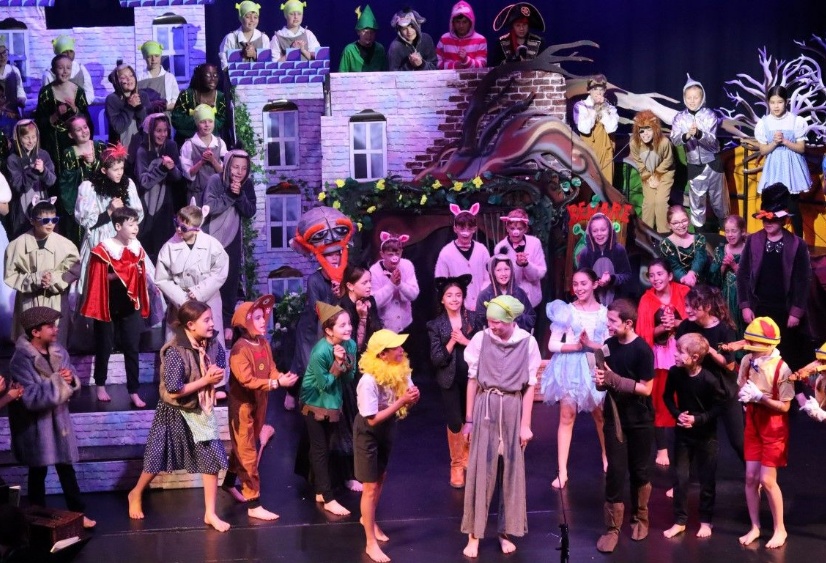 60 children dressed as fairytale characters act out a scene in Shrek The Musical JR in Heath Mount School's state of the art theatre